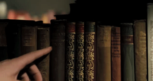 finger-passes-along-book-spines-library-animated-gif